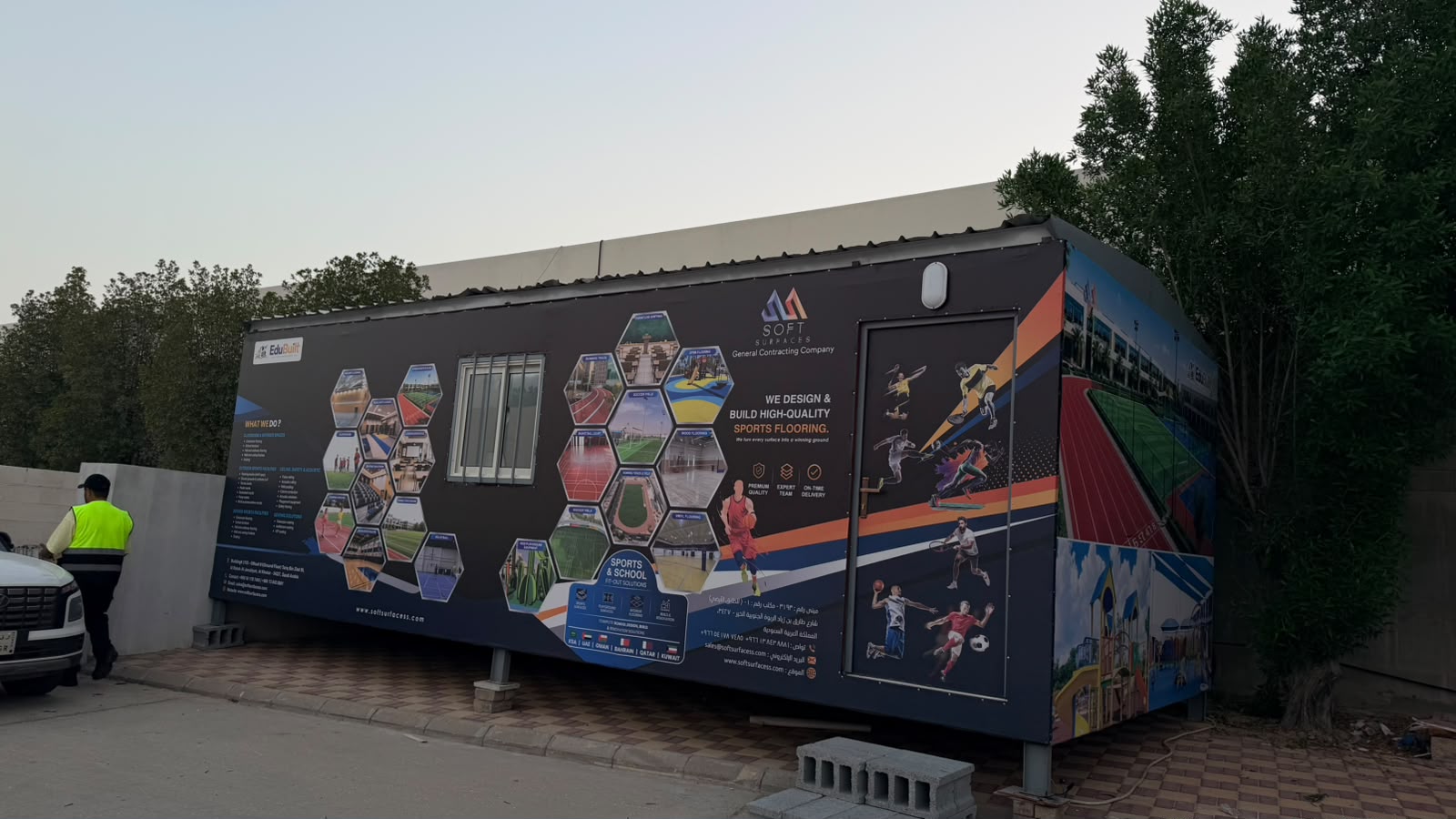 Wide exterior view of the branded Soft Surfaces site office